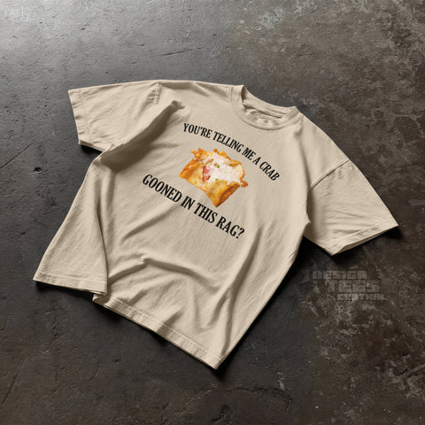 Sand-colored t-shirt printed with a photo of a crab rangoon and the text You're Telling Me a Crab Gooned in This Rag.
