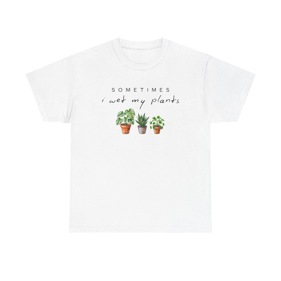 White t-shirt printed with the words Sometimes I Wet My Plants in script above three watercolor houseplants in pots.
