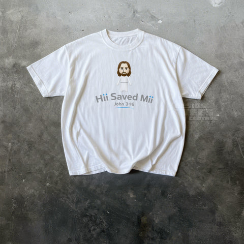 White t-shirt printed with a small blocky cartoon figure in a white robe above the text Hii Saved Mii and John 3:16.