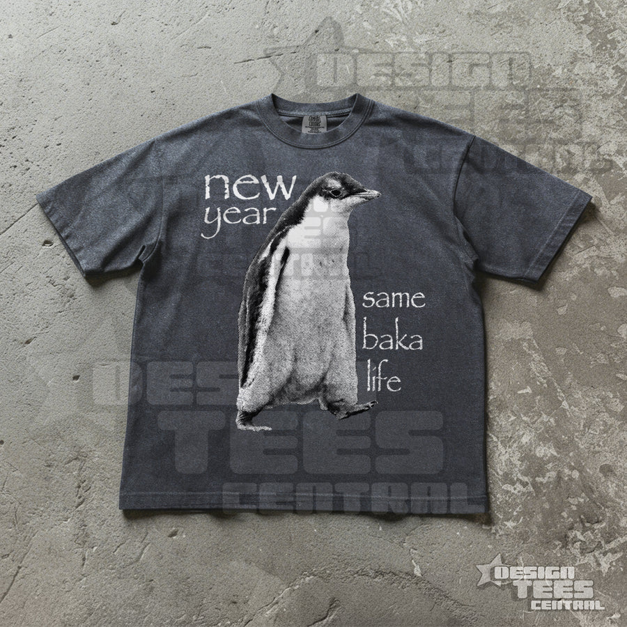 Faded charcoal t-shirt printed with a greyscale penguin chick and the white words new year same baka life.
