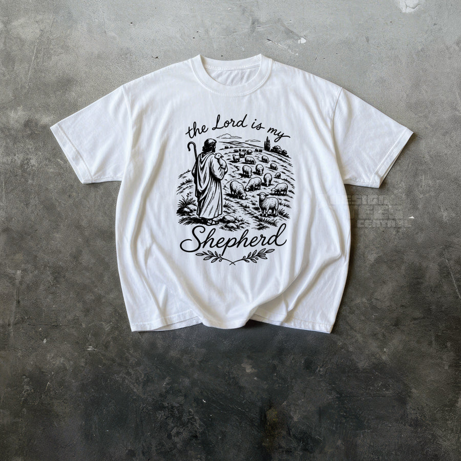 White t-shirt printed with black line art of a shepherd with a staff among sheep and the text the Lord is my Shepherd.